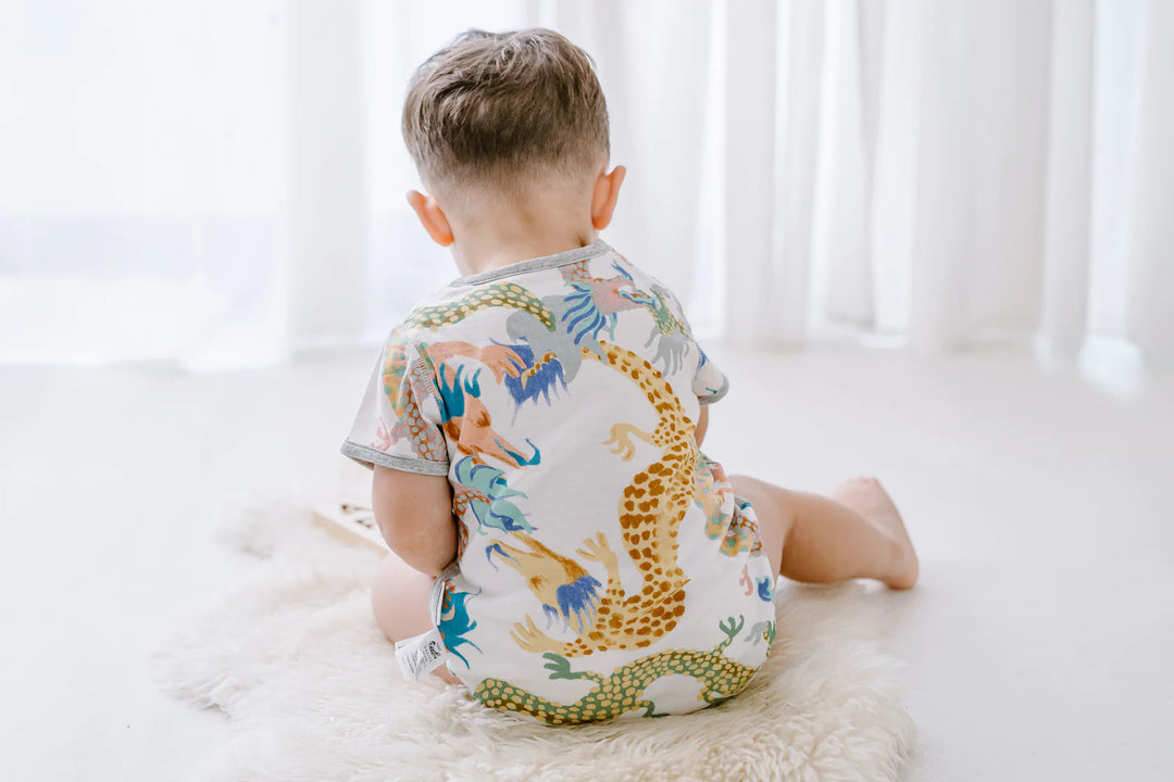 Back view of a child wearing the Short Sleeve Onesie (Bamboo) - Dragon Dance (Sizes 12 Months - 2T)