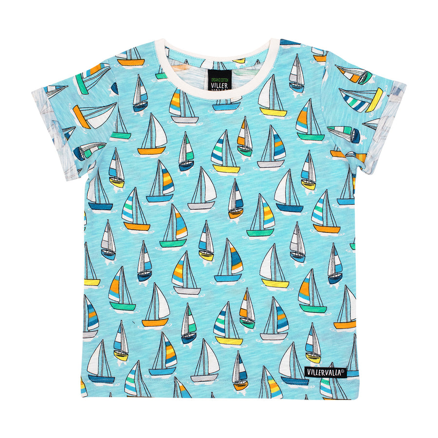 Light blue childs shirt with sailboats in various colours of. Features a gentle rolled sleeve