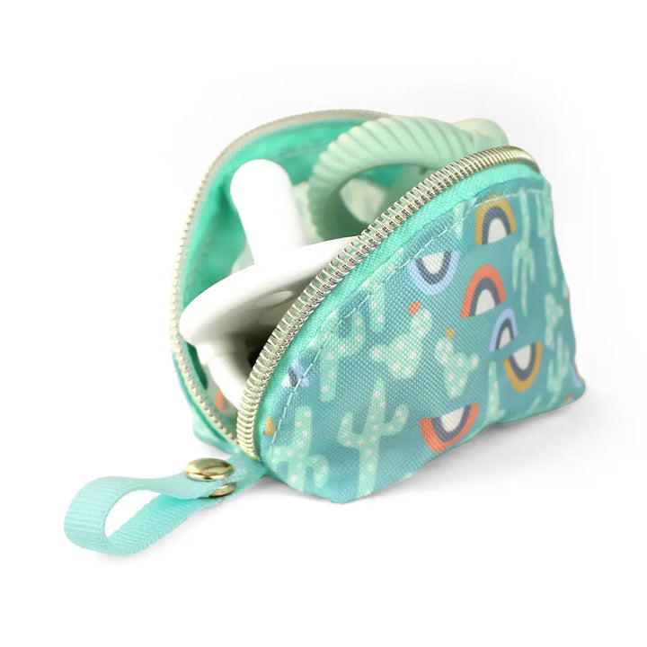 Cactus Itzy Ritzy Pacifier Pouch holding two sage sweetie soothers