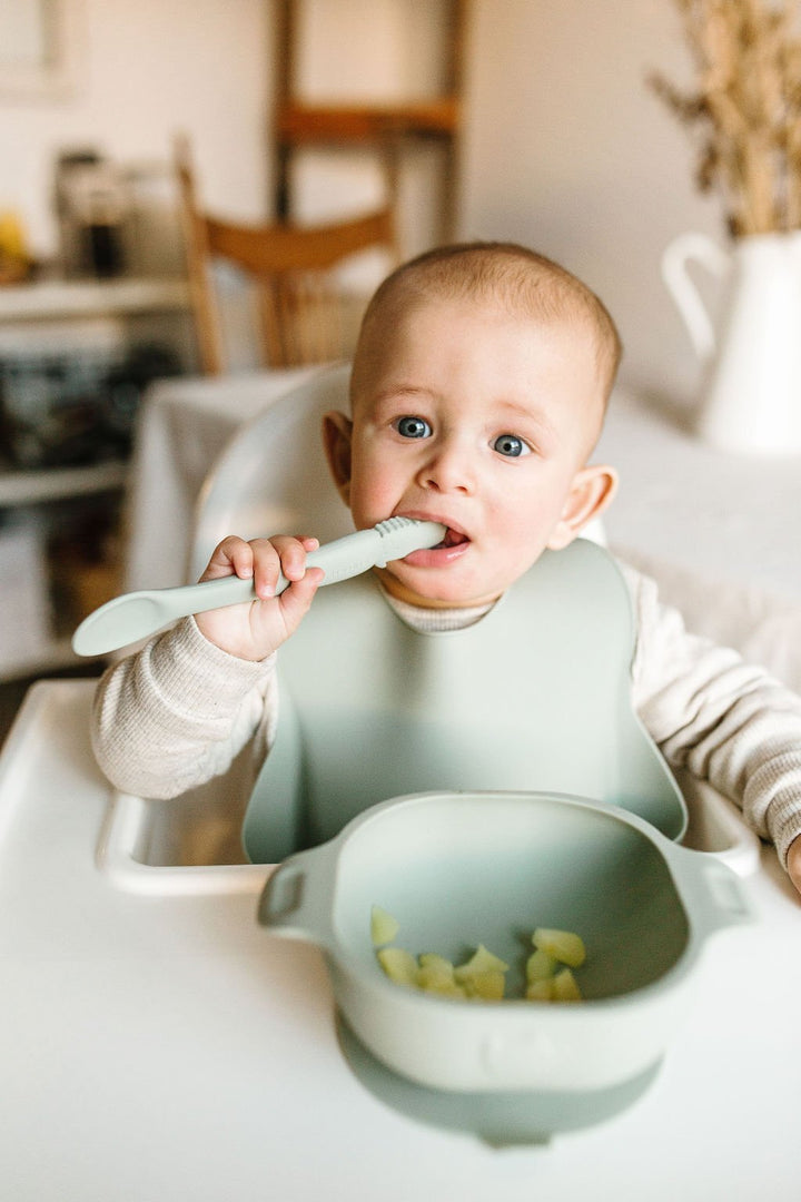 baby chewing on a Silicone Infant Feeding Spoon from LouLou Lollipop