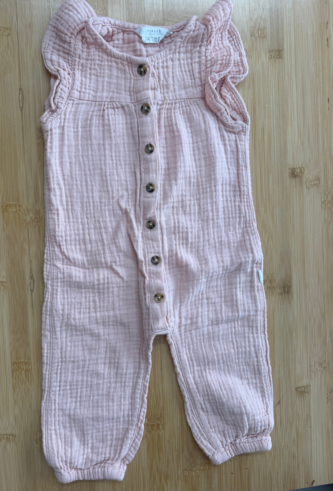 First by Petit Lem Romper – 12 Months | Pink Muslin | Button Down | Ruffle Cap Sleeves