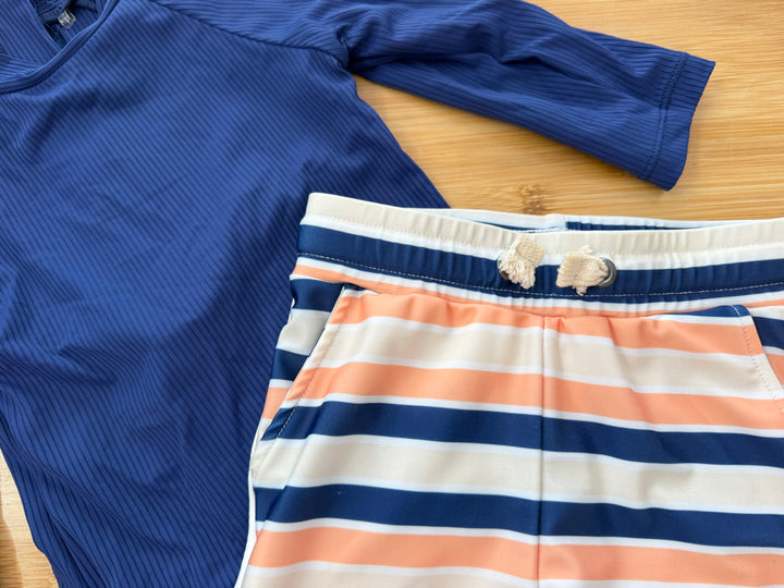 Little Buck Two-Piece Swim Set – 12–18M | Royal Blue Rash Guard & Blue/Orange Stripe Shorts