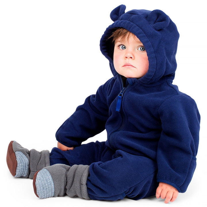 Jan & Jul Fleece Suit | Baby Outerwear baby sitting in a navy blue version wearing stay put cozy booties. 