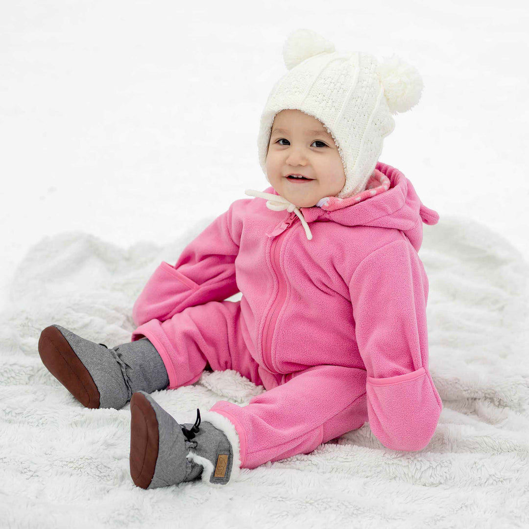 Baby sitting in the Jan & Jul Fleece Suit | Baby Outerwear in the colour way watermelon pink