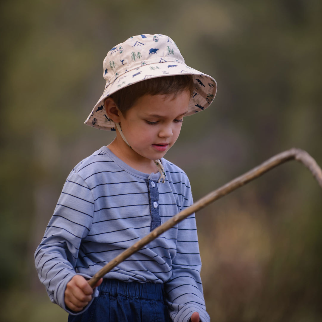 Child wearing Jan & Jul Cotton Bucket Hat in Bear Camp outside