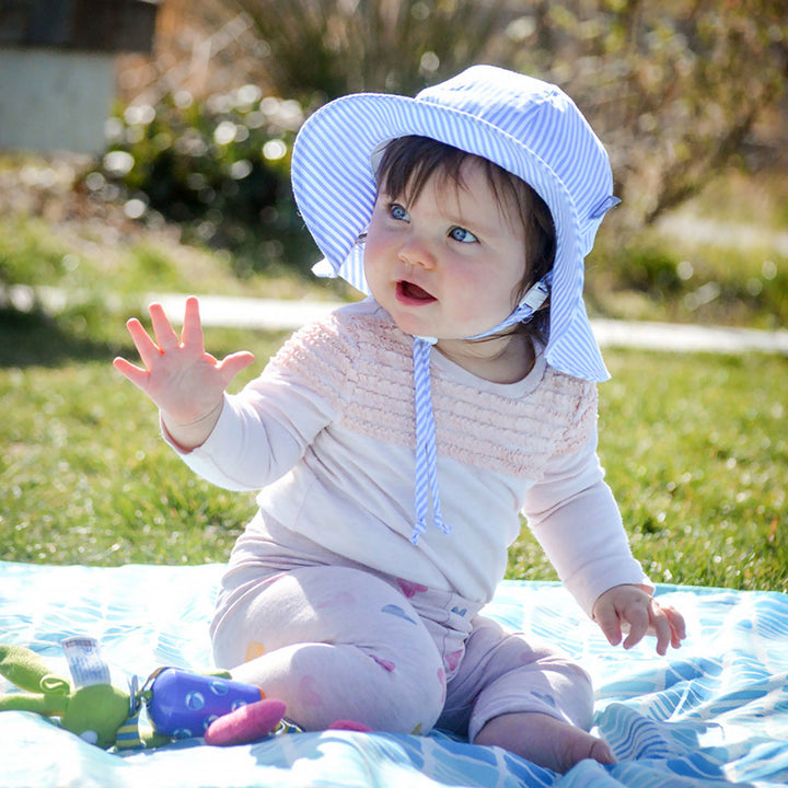 Jan & Jul Cotton Floppy Hat in Blue Stripes on baby in the sunb