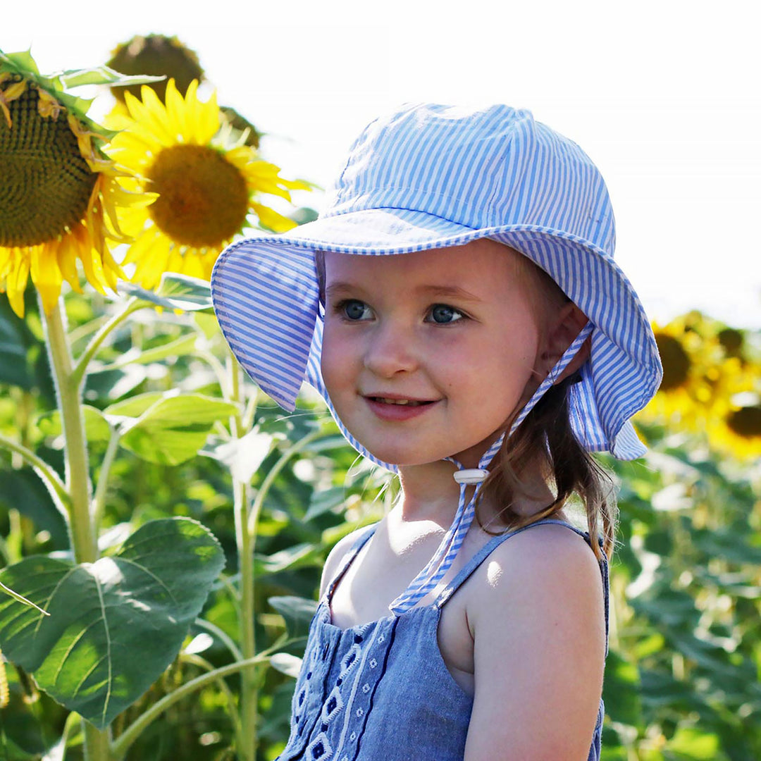 Jan & Jul Cotton Floppy Hat on a child in the sunflower field