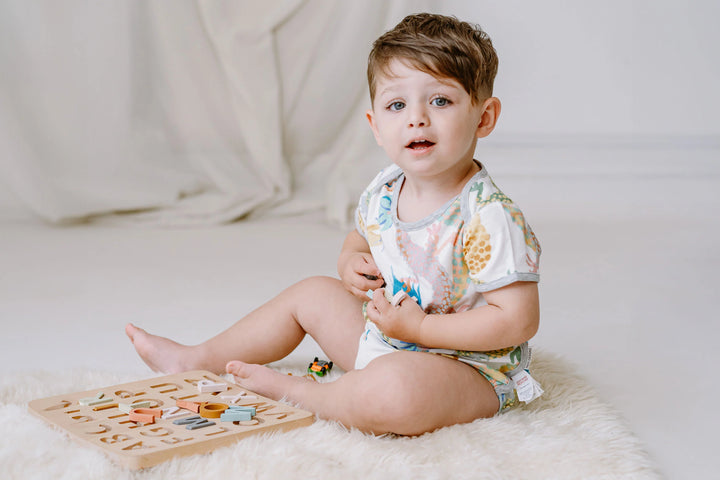 Lifestyle photo of a child in Short Sleeve Onesie (Bamboo) - Dragon Dance (Sizes 12 Months - 2T)