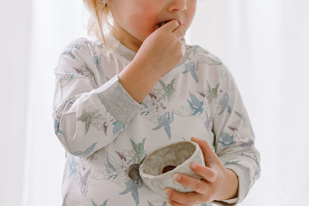 Lifestyle image of a child wearing Kids Two-Piece Pajama Set  - Cloud Ponies