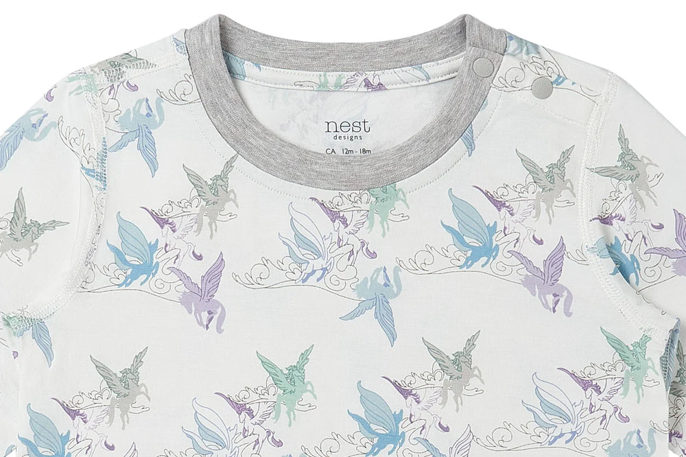 Neckline and snaps on the the long sleeve shirt of the pajama set from Nest Designs with the print Cloud Ponies in light blue, purple, green and grey
