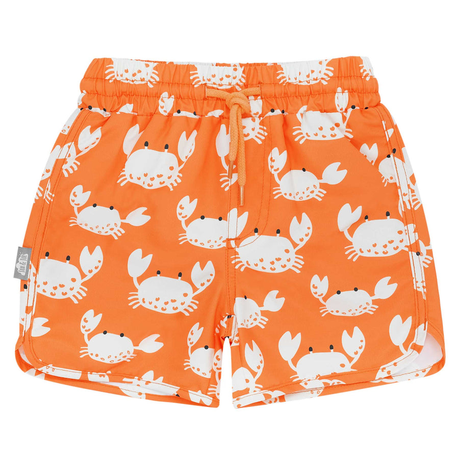 Flay lay of Jan & Jul UV Swim Shorts | Crabby Crab featuring a brigh torange print with drawstring and white crab print