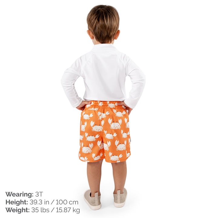 Back view - Child wearing Jan & Jul UV Swim Shorts | Crabby Crab. The child is a size 3T at 35lbs and 39.3 tall. Child is also wearing a white rash guard, and Jan and Jul Explore Shoes in a beige colour. 