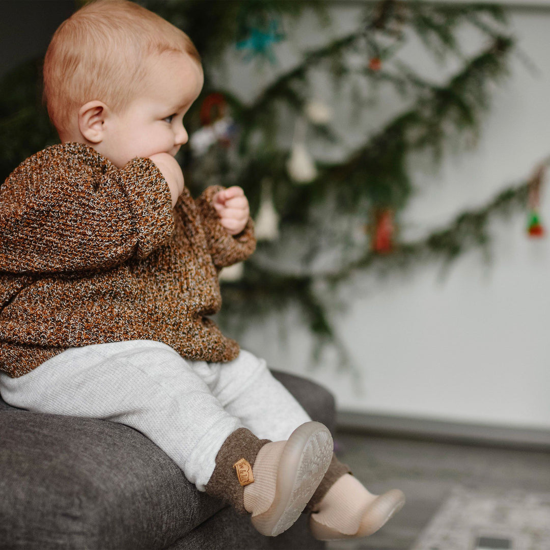 Lifestyle image of a baby wearing the oatmeal Cozy Sock Shoe | Jan & Jul