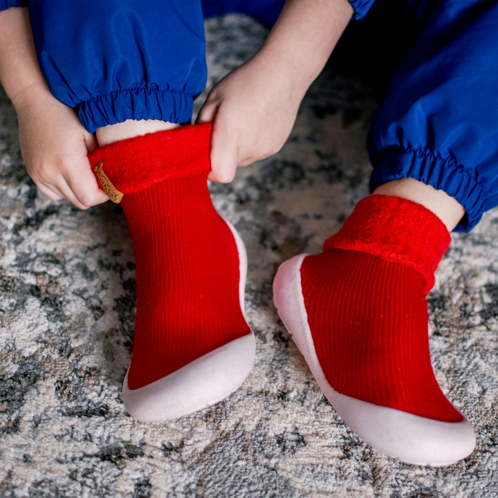 lifestyle image of a child easily pulling on the Cozy Sock Shoe | Jan & Jul