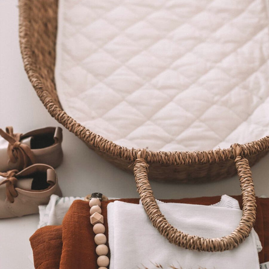 Organic Cotton Insert in a rattan changing basket lifestyle photo